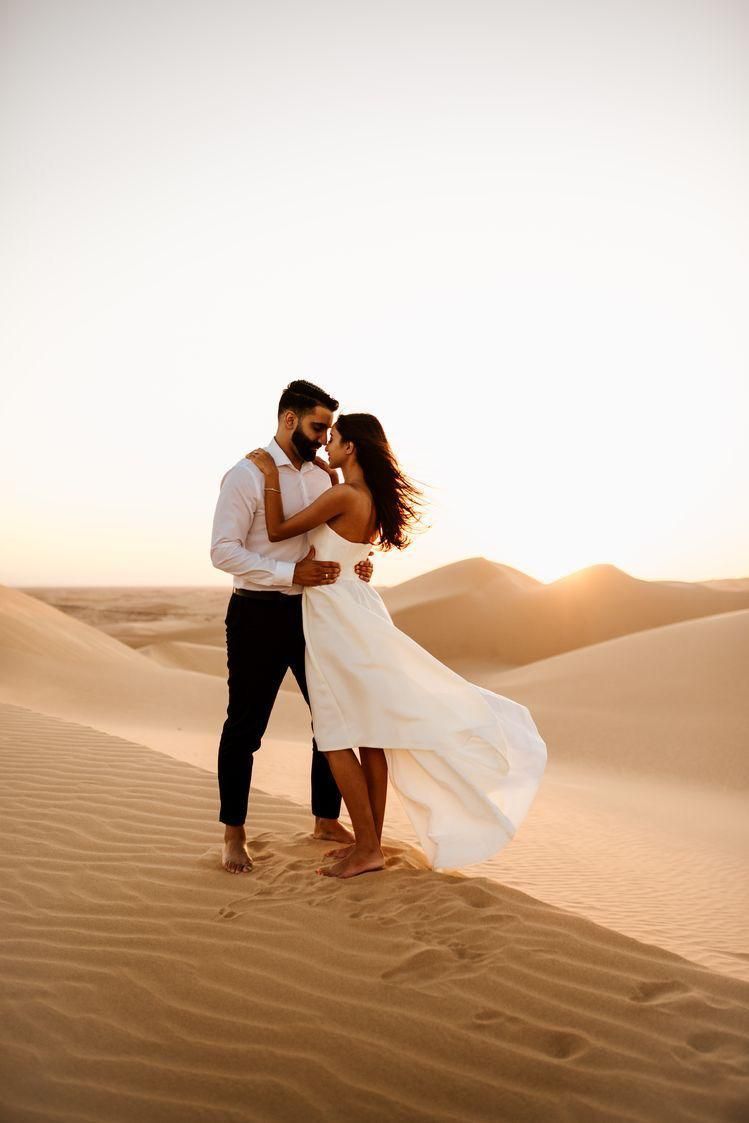 Romantic couple portrait during golden hour Dubai desert photoshoot