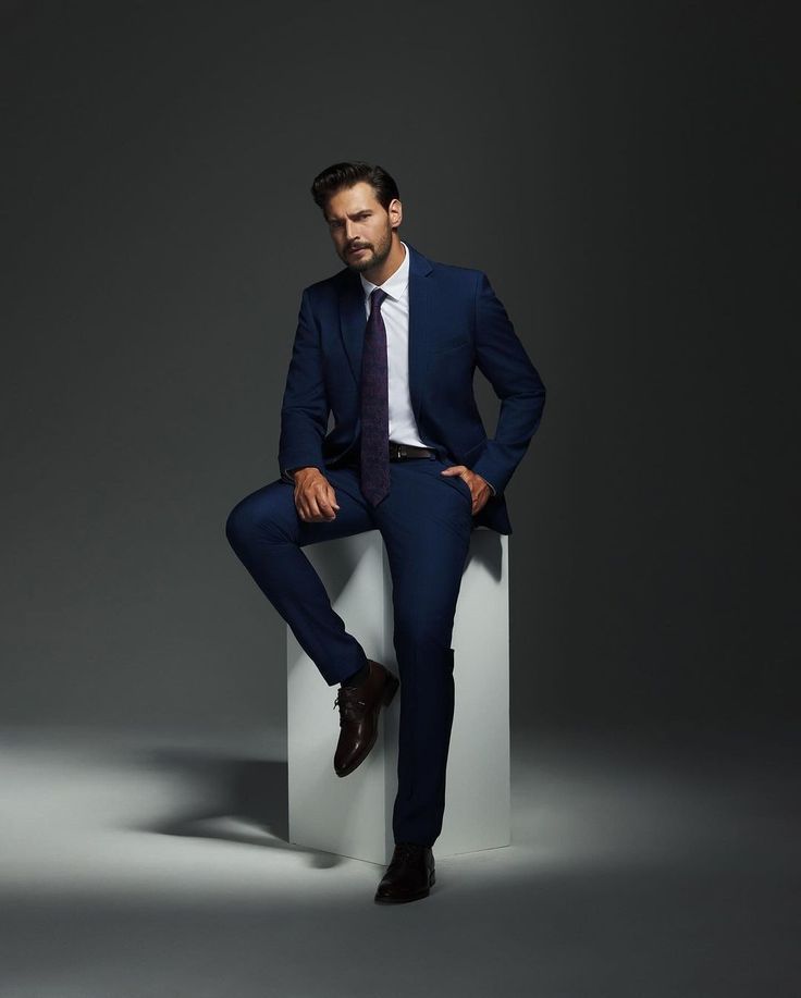 Confident executive in a premium tailored suit posed in a refined studio environment, symbolizing exclusivity and high-end professional dating culture.