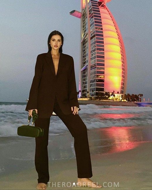 a branding photo from a woman with Burj Al Arab view in afternoon