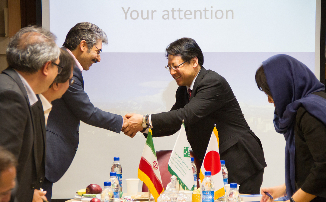 VIP handshake and agenda moment at a corporate event.